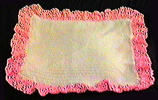 White blanket with pink trim